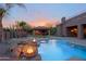 Stunning backyard oasis with a pool, spa, fire features, and an outdoor kitchen and bar area at 13627 E Monument Dr, Scottsdale, AZ 85262