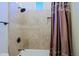 Elegant tiled shower featuring bronze fixtures and a custom niche at 13627 E Monument Dr, Scottsdale, AZ 85262