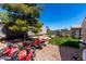 This spacious backyard boasts a grassy area, gravel landscaping, a pine tree, and perimeter block fencing at 1428 W Mesquite Ave, Apache Junction, AZ 85120
