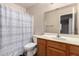 Bathroom with vanity, toilet, and shower with curtain at 1428 W Mesquite Ave, Apache Junction, AZ 85120