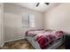 Bedroom features a window with blinds, a bed, and neutral wall color at 1428 W Mesquite Ave, Apache Junction, AZ 85120