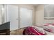 Bedroom featuring closet with sliding door and window for natural light at 1428 W Mesquite Ave, Apache Junction, AZ 85120