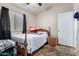 Bedroom with a window, ceiling fan and wooden bed at 1428 W Mesquite Ave, Apache Junction, AZ 85120