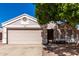 Charming single-story home with a two-car garage and low-maintenance desert landscaping at 1428 W Mesquite Ave, Apache Junction, AZ 85120