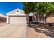 Charming single-story home with a two-car garage and low-maintenance desert landscaping at 1428 W Mesquite Ave, Apache Junction, AZ 85120