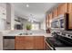 Well-lit kitchen with stainless steel appliances and white countertops overlooking the living area at 1428 W Mesquite Ave, Apache Junction, AZ 85120