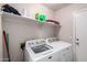 Laundry room with white washer and dryer and shelving for storage at 1428 W Mesquite Ave, Apache Junction, AZ 85120