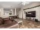Spacious living room with tile floors, a ceiling fan, and comfortable leather furniture at 1428 W Mesquite Ave, Apache Junction, AZ 85120