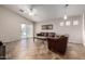 Bright living room with tile flooring, ceiling fan, and sliding glass door to the patio at 1428 W Mesquite Ave, Apache Junction, AZ 85120