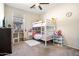 Cozy bedroom featuring a bunk bed, neutral walls, ceiling fan and bright natural light at 14966 W Virginia Ave, Goodyear, AZ 85395