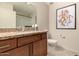 Bathroom features a granite countertop vanity and a large mirror with eye-catching decor at 15050 N Thompson Peak Pkwy # 1035, Scottsdale, AZ 85260