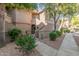 Exterior view of a two-story home with well-maintained landscaping and covered entryway at 15050 N Thompson Peak Pkwy # 1035, Scottsdale, AZ 85260