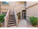 Exterior stairs leading to a front entryway of a two-story home with desert landscape at 15050 N Thompson Peak Pkwy # 1035, Scottsdale, AZ 85260