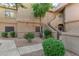 Exterior shot of a two-story home with mature trees, and desert landscaping at 15050 N Thompson Peak Pkwy # 1035, Scottsdale, AZ 85260