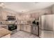 Well-lit kitchen featuring stainless steel appliances, granite countertops, and neutral-toned cabinets at 15050 N Thompson Peak Pkwy # 1035, Scottsdale, AZ 85260