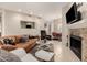 Open-concept living area with fireplace, comfortable seating, and a view into the dining area at 15050 N Thompson Peak Pkwy # 1035, Scottsdale, AZ 85260
