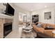 Comfortable living area with fireplace, sofa, unique decor, and a view to another room at 15050 N Thompson Peak Pkwy # 1035, Scottsdale, AZ 85260