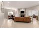 Spacious living room with fireplace, leather sofa, tile flooring, and a view into the dining area at 15050 N Thompson Peak Pkwy # 1035, Scottsdale, AZ 85260