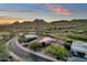 Aerial view of a luxury home nestled among a golf course, offering scenic mountain views at sunset at 15106 E Miravista --, Fountain Hills, AZ 85268