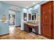 Bathroom vanity with granite countertop and dark wood cabinets with travertine flooring and an archway at 15106 E Miravista --, Fountain Hills, AZ 85268