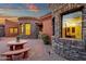 Home featuring circular stone design, with a patio featuring a decorative table and landscaped entrance at 15106 E Miravista --, Fountain Hills, AZ 85268