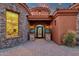 Home featuring circular stone design, landscaped entrance, decorative table, and a decorative iron gate at 15106 E Miravista --, Fountain Hills, AZ 85268