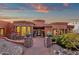 Elegant home featuring a circular stone design, a landscaped entrance, and a decorative iron gate at 15106 E Miravista --, Fountain Hills, AZ 85268