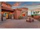 Home featuring circular stone design, with a patio featuring a decorative table and landscaped entrance at 15106 E Miravista --, Fountain Hills, AZ 85268