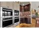 Gourmet kitchen boasts stainless steel appliances and dark wood cabinetry with stylish countertops and floors at 15106 E Miravista --, Fountain Hills, AZ 85268