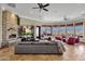 Comfortable living room boasts a stone fireplace, tv, generous seating, and a beautiful view from the many windows at 15106 E Miravista --, Fountain Hills, AZ 85268
