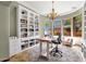 Bright home office with built-in bookshelves, a chandelier, and large windows offering outdoor views at 15106 E Miravista --, Fountain Hills, AZ 85268