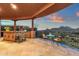 Covered patio featuring an outdoor kitchen, dining area and sunset views of the surrounding area at 15106 E Miravista --, Fountain Hills, AZ 85268