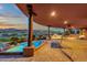 Covered outdoor patio with pool, lounge chairs, and panoramic views, perfect for entertaining and relaxation at 15106 E Miravista --, Fountain Hills, AZ 85268