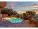 Kidney shaped pool surrounded by lush desert landscaping, plants and rock features at 15106 E Miravista --, Fountain Hills, AZ 85268