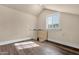 Finished attic space with hardwood floors, bright natural light, and small door to crawlspace at 1533 W Culver St, Phoenix, AZ 85007