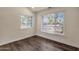 Well-lit bedroom featuring two windows, complemented by wood floors and neutral walls at 1533 W Culver St, Phoenix, AZ 85007