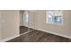Cozy bedroom with a mirrored closet and a window providing natural light, complemented by wood floors at 1533 W Culver St, Phoenix, AZ 85007