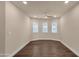 Bedroom featuring hardwood floors, neutral paint, and natural light from three windows at 1533 W Culver St, Phoenix, AZ 85007