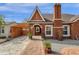 Charming brick home with a brick chimney and landscaped front yard, showcasing classic architectural details at 1533 W Culver St, Phoenix, AZ 85007