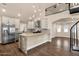 Open kitchen featuring stainless steel appliances, marble counters, and adjacent living and dining area at 1533 W Culver St, Phoenix, AZ 85007
