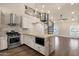 Gourmet kitchen featuring stainless steel appliances, marble counters, and spiral staircase at 1533 W Culver St, Phoenix, AZ 85007