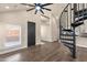 Bright living room with a unique spiral staircase, modern ceiling fan, and hardwood floors at 1533 W Culver St, Phoenix, AZ 85007