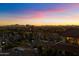 Community aerial view at sunset, showcasing the surrounding greenery and city lights at 15802 N 71St St # 754, Scottsdale, AZ 85254