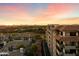 Scenic aerial view featuring condominiums, golf course, and mountain views at sunset at 15802 N 71St St # 754, Scottsdale, AZ 85254