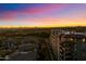 Condo building with a sunset sky in the background and a golf course in the foreground at 15802 N 71St St # 754, Scottsdale, AZ 85254