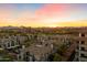 Aerial view of the community and sunset over mountains creating a picturesque and desirable location at 15802 N 71St St # 754, Scottsdale, AZ 85254