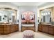 A stylish bathroom features dual vanities, marble counters, and a makeup vanity nook with designer lighting at 15802 N 71St St # 754, Scottsdale, AZ 85254