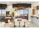 Modern dining area features a contemporary chandelier, access to a balcony, and a serving bar nearby at 15802 N 71St St # 754, Scottsdale, AZ 85254