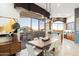 Modern dining area features a contemporary chandelier, access to a balcony, and a wet bar nearby at 15802 N 71St St # 754, Scottsdale, AZ 85254