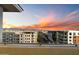 Balcony view showcasing modern buildings and mountains against a vibrant sunset at 15802 N 71St St # 754, Scottsdale, AZ 85254